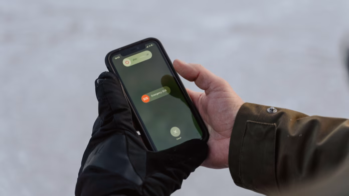 Pessoa olhando o celular enquanto usa redes sociais e checa mensagens